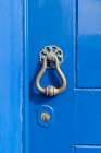 Angra do Heroismo, Terceira Island, Azores, Portugal. Brass knocker on a blue painted door. Art Print